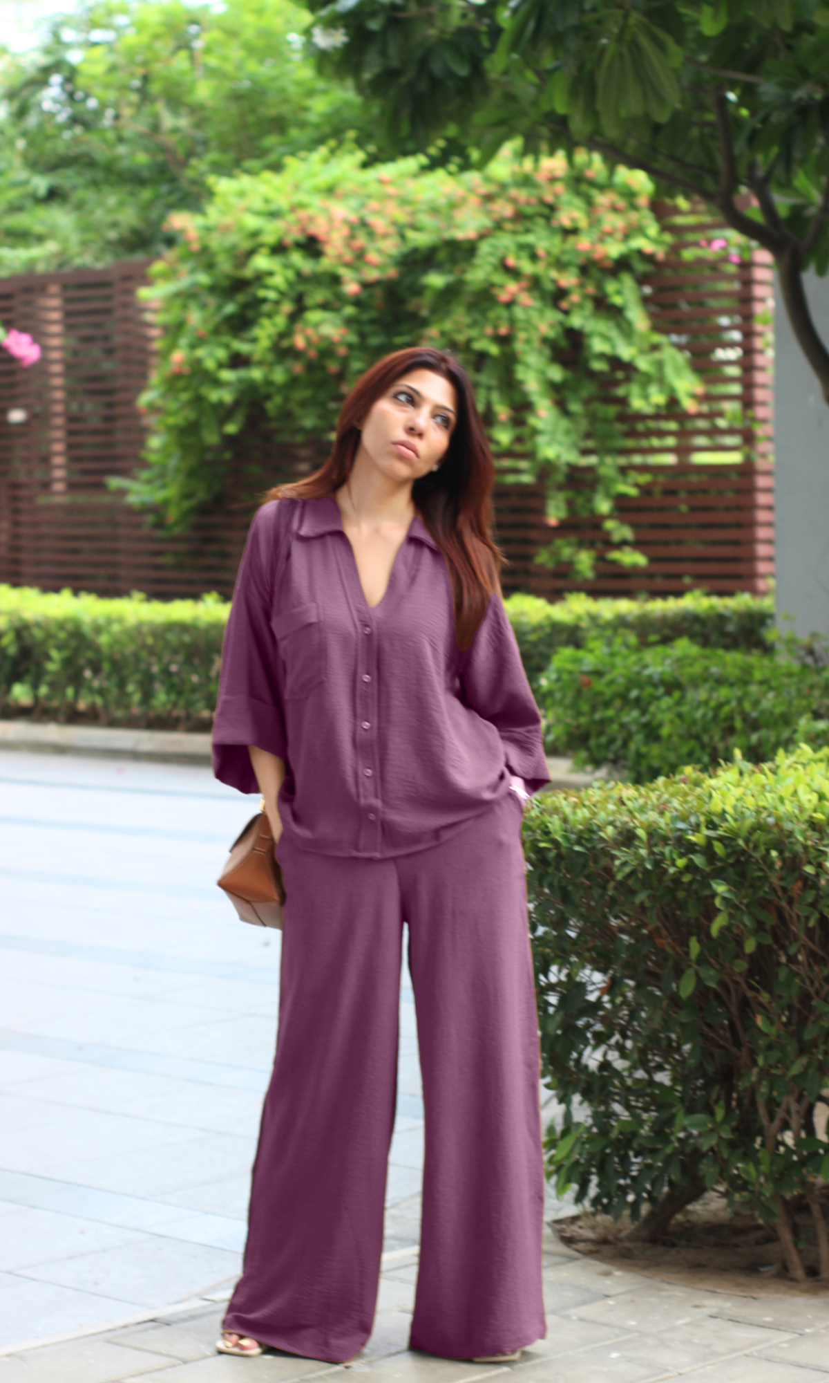 Plum co-ord set with half-sleeve shirt and wide-leg pants, styled outdoors.