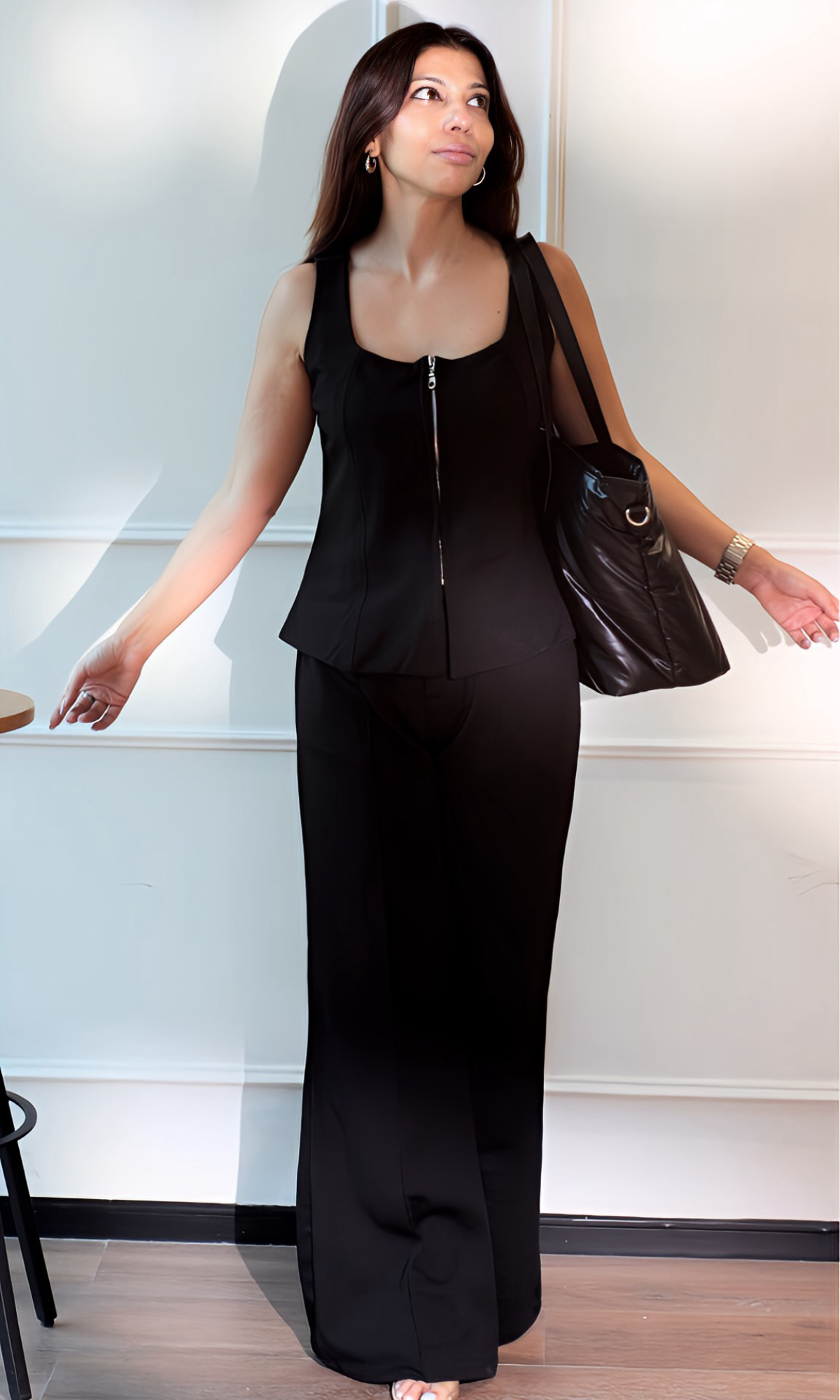 Elegant monochrome outfit: Noir Zip Detail Top with front zipper paired with tailored black flared pants.