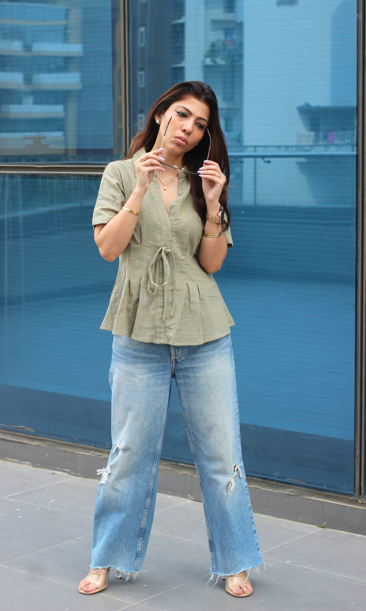 Olive green top with a V-neck and collar, featuring subtle pinstripes and an adjustable drawstring waist for a custom fit.