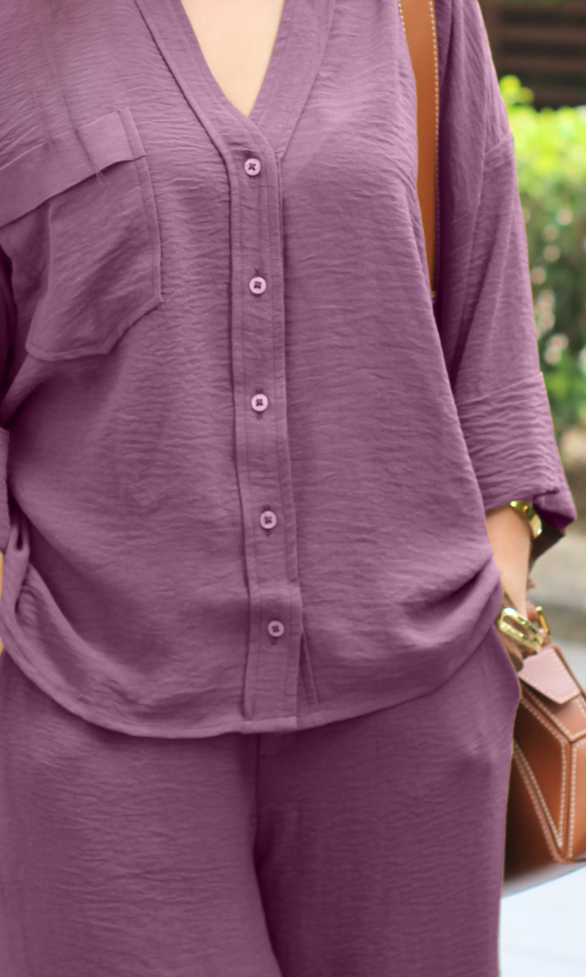 Textured mauve taupe co-ord with button shirt and flared trousers.
