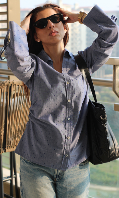 Texture close-up of blue dobby cotton shirt featuring string detailing