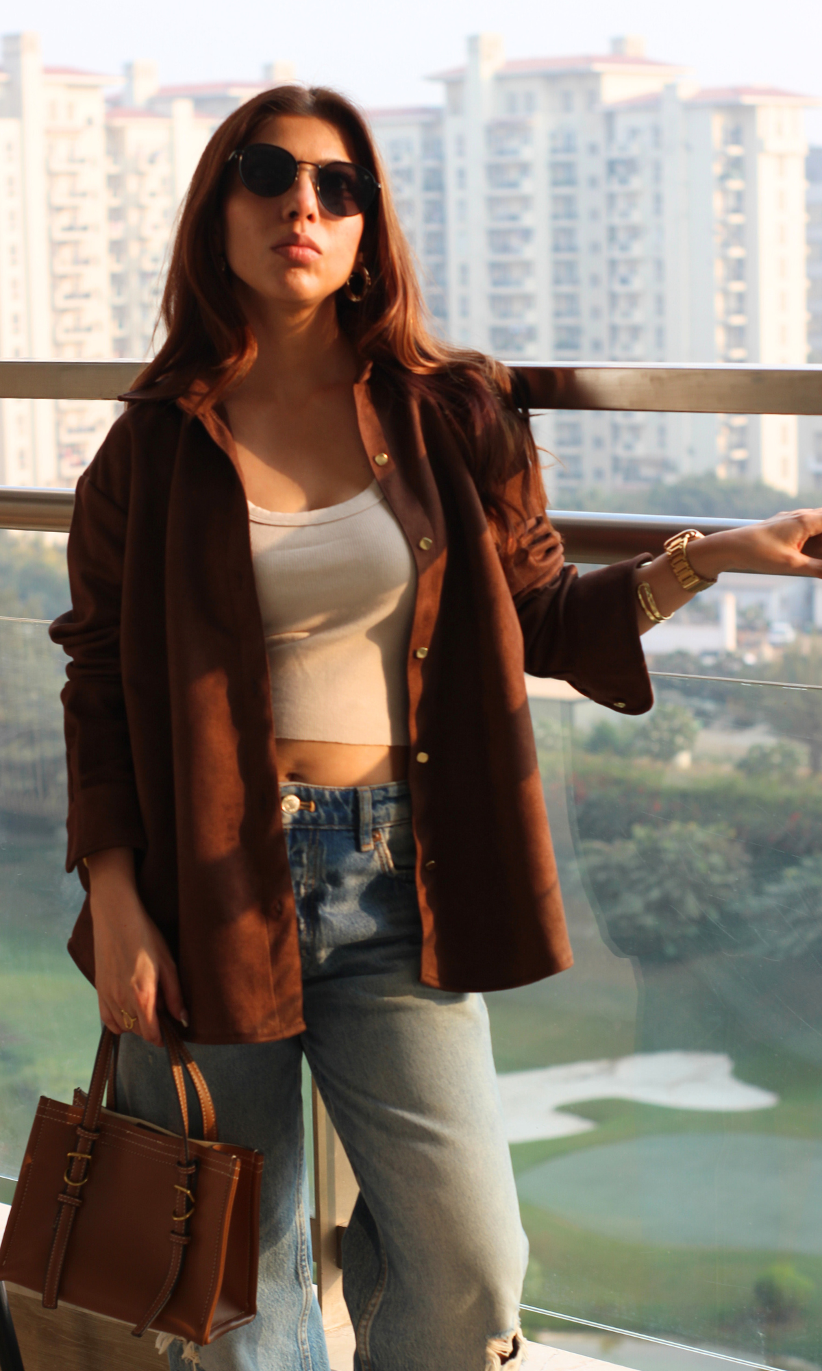 Women’s coffee-brown suede shirt with full long sleeves and gold-tone metallic button-front closure — luxe texture for day-to-night wear.