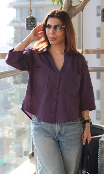 Woman wearing a midnight purple cotton cropped shirt styled with high-waist bottoms