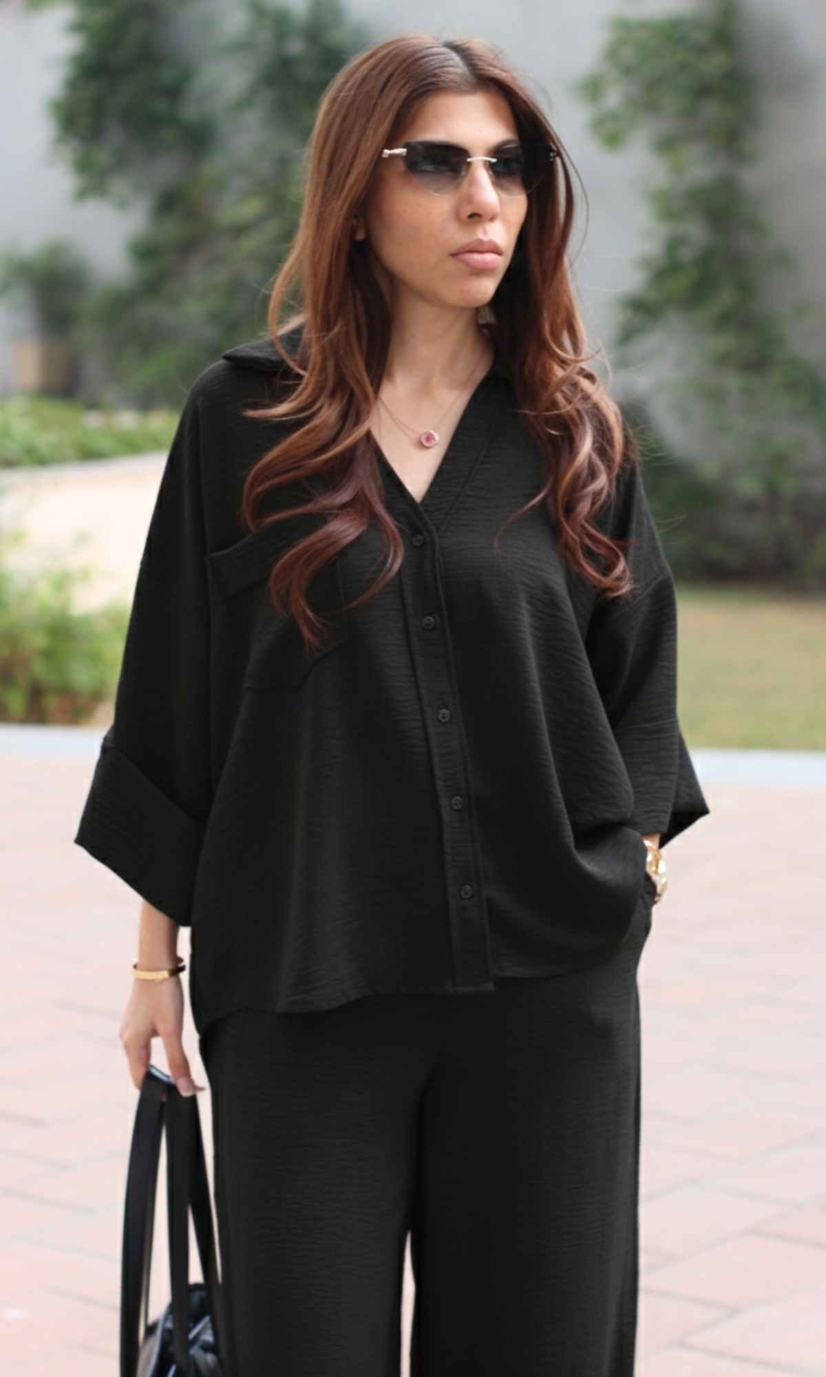 Model wearing smoke black co-ord set with airy shirt and relaxed pants silhouette