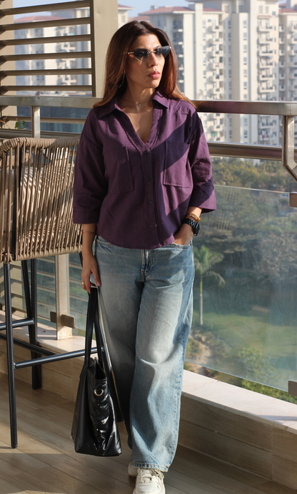 Woman wearing a midnight purple cotton cropped shirt styled with high-waist bottoms