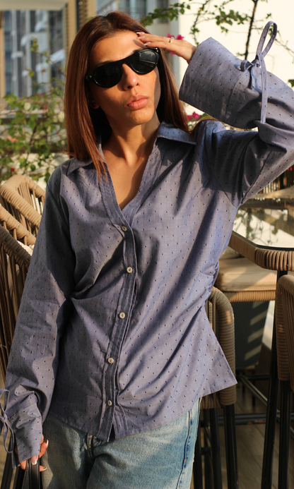 Close-up view of blue dobby weave cotton shirt with fine string detail