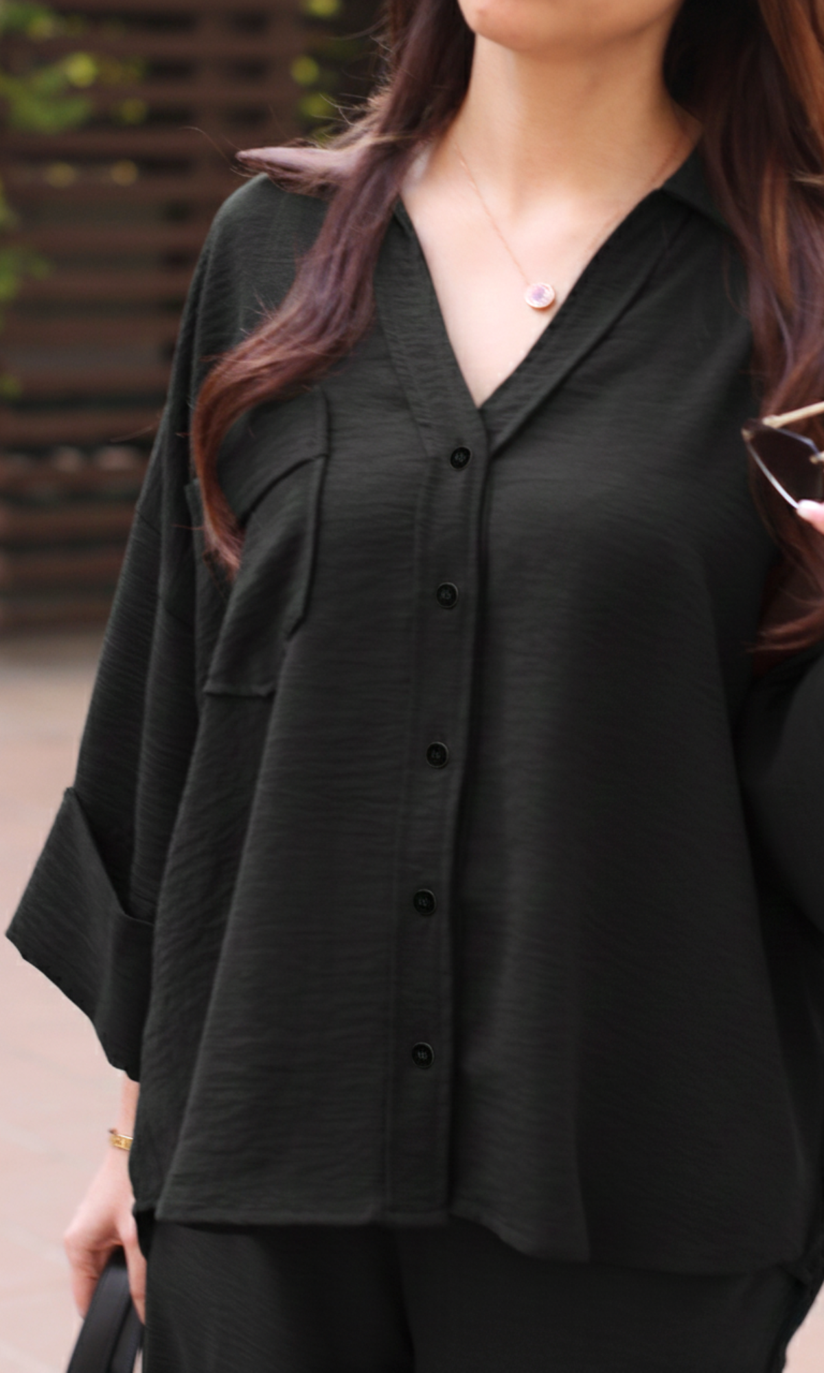 Detailed view of smoke black co-ord set highlighting fabric weave and finish