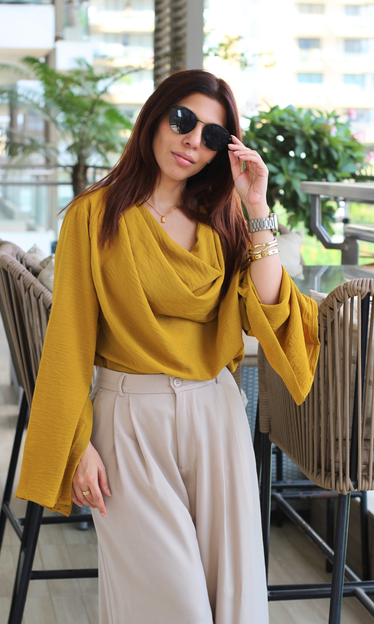 Lightweight mustard cowl neck blouse with elegant sleeve slits styled for a breezy, minimal outfit.