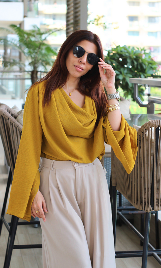 Lightweight mustard cowl neck blouse with elegant sleeve slits styled for a breezy, minimal outfit.