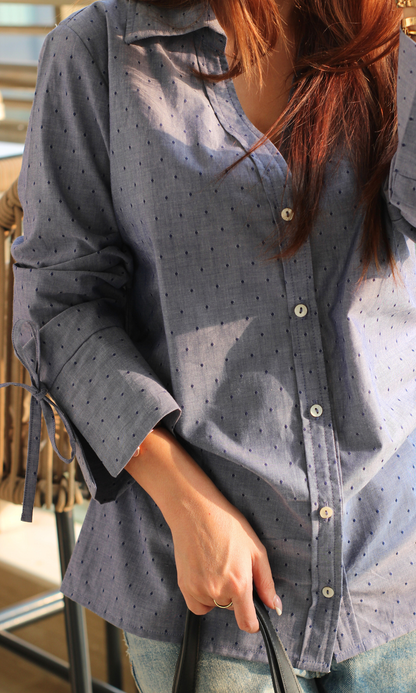 Close-up of blue dobby cotton shirt showing string detail and textured weave