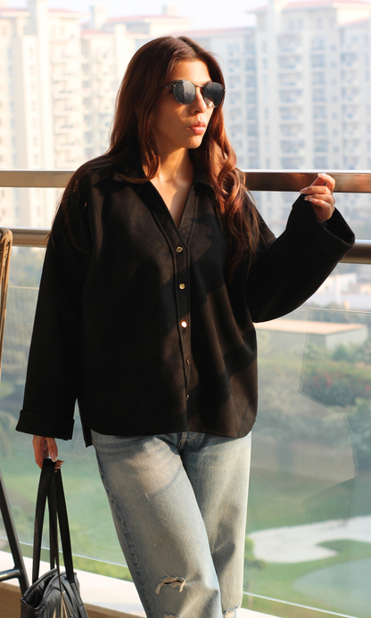 Women’s black suede metallic-button shirt with long sleeves, sleek button-front closure and luxe textured finish — perfect for evening or smart-casual wear.