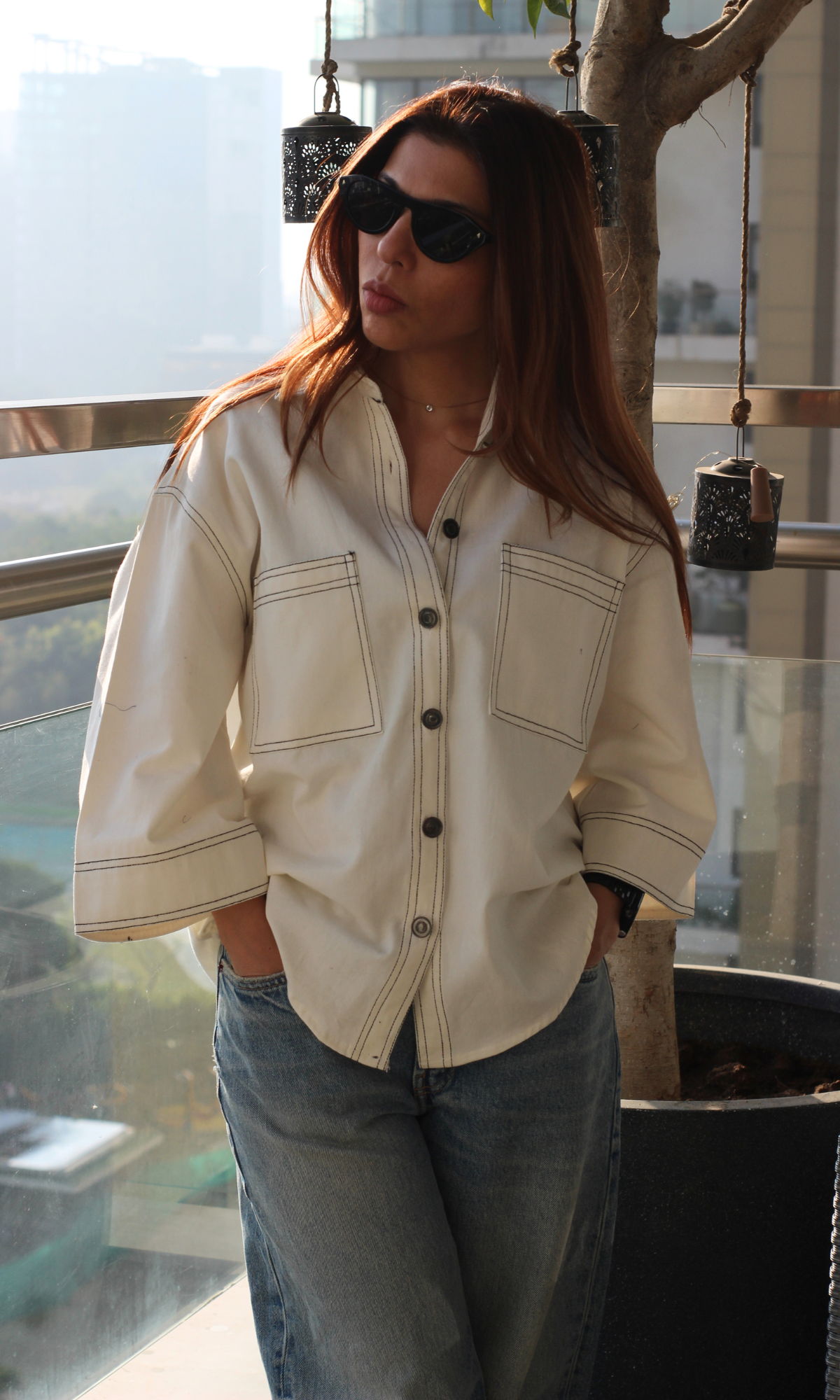 White thread detail shirt styled casually with a soft drape and long sleeves