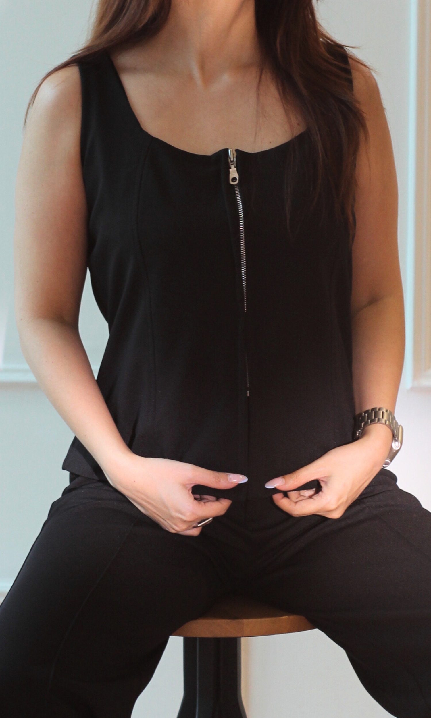 Close-up of the Noir Zip Detail Top and Flared Pants Co-ord highlighting the structured zip-front top and smooth black fabric.