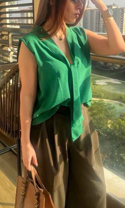 Close‑up of green top showing fabric texture and front tie detail