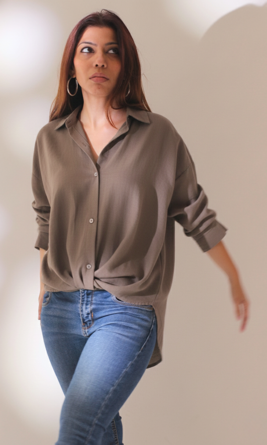 Front view of women’s greige shirt with elegant knot accent and classic collar