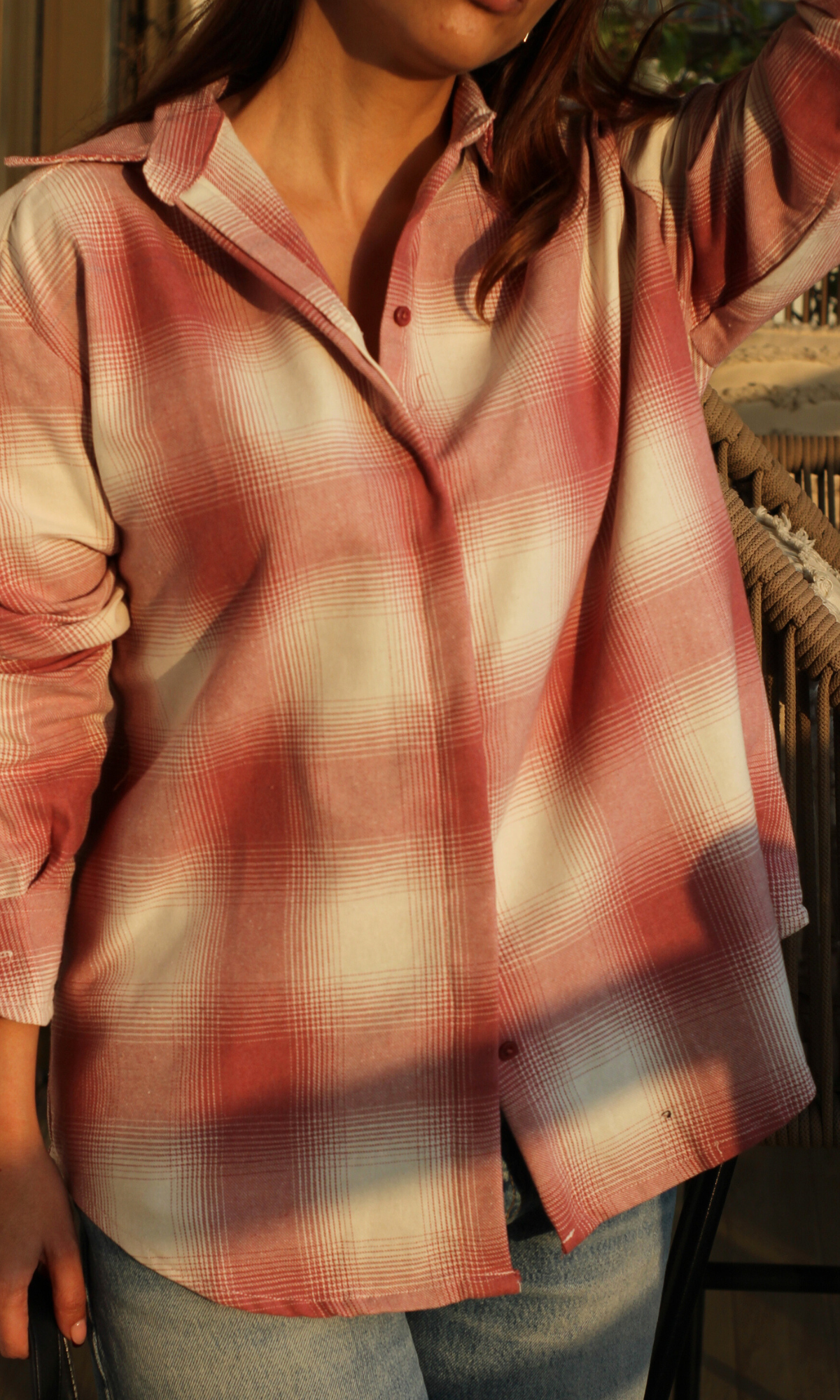 Close-up of pink ivory plaid check fabric on women’s shirt