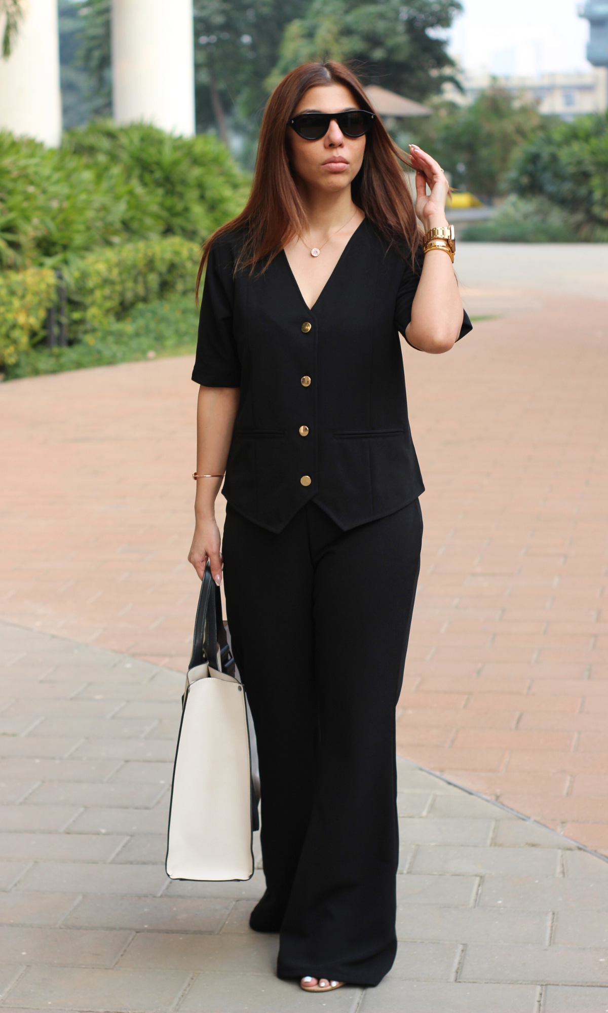 Chic black sleeved waistcoat and flared pants co-ord set for a polished look