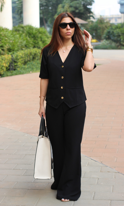 Chic black sleeved waistcoat and flared pants co-ord set for a polished look
