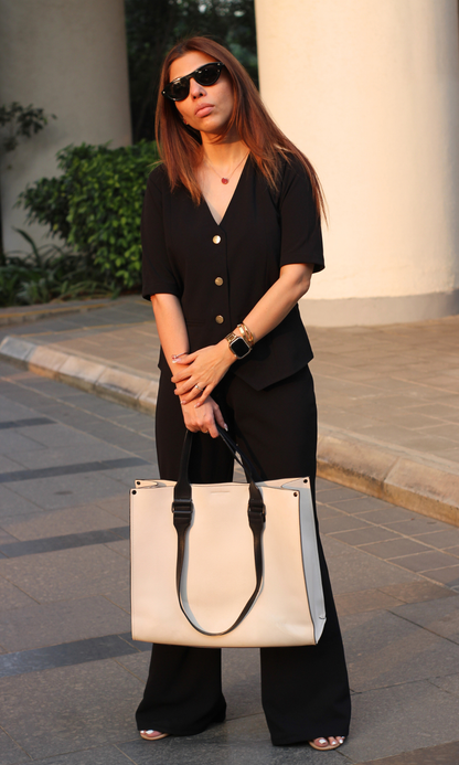 Elegant black sleeved waistcoat paired with high-waisted flared pants