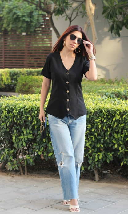 Model wearing onyx sleeved waist coat styled with trousers highlighting modern cut