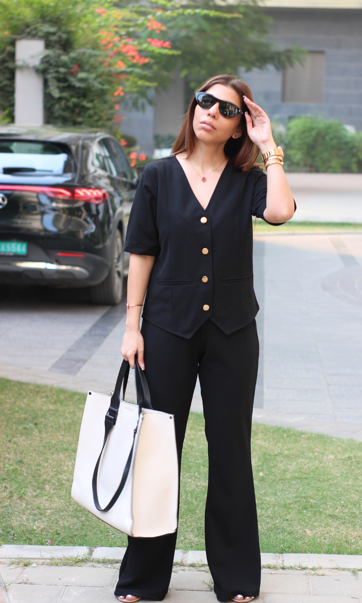 Stylish black two-piece set: waistcoat with sleeves and matching flared pants