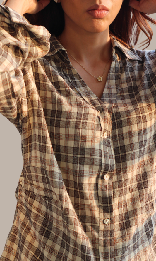 Close-up of brown and cream check cotton fabric with visible string detailing
