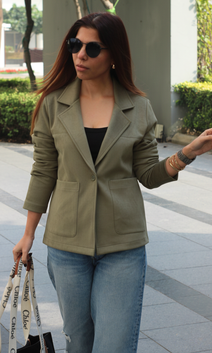 Olive-grey suede outerwear for women featuring full sleeves, structured collar and front button closure — perfect for layering in transitional seasons.