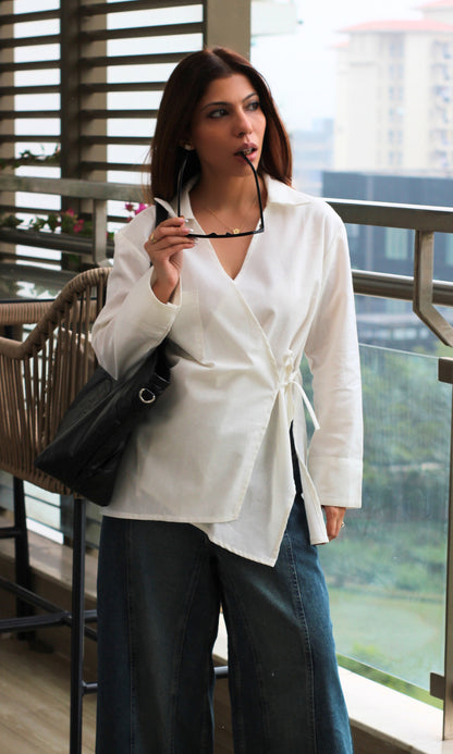 Women’s white kimono top in linen fabric featuring subtle cut-detail design and relaxed wrap fit.