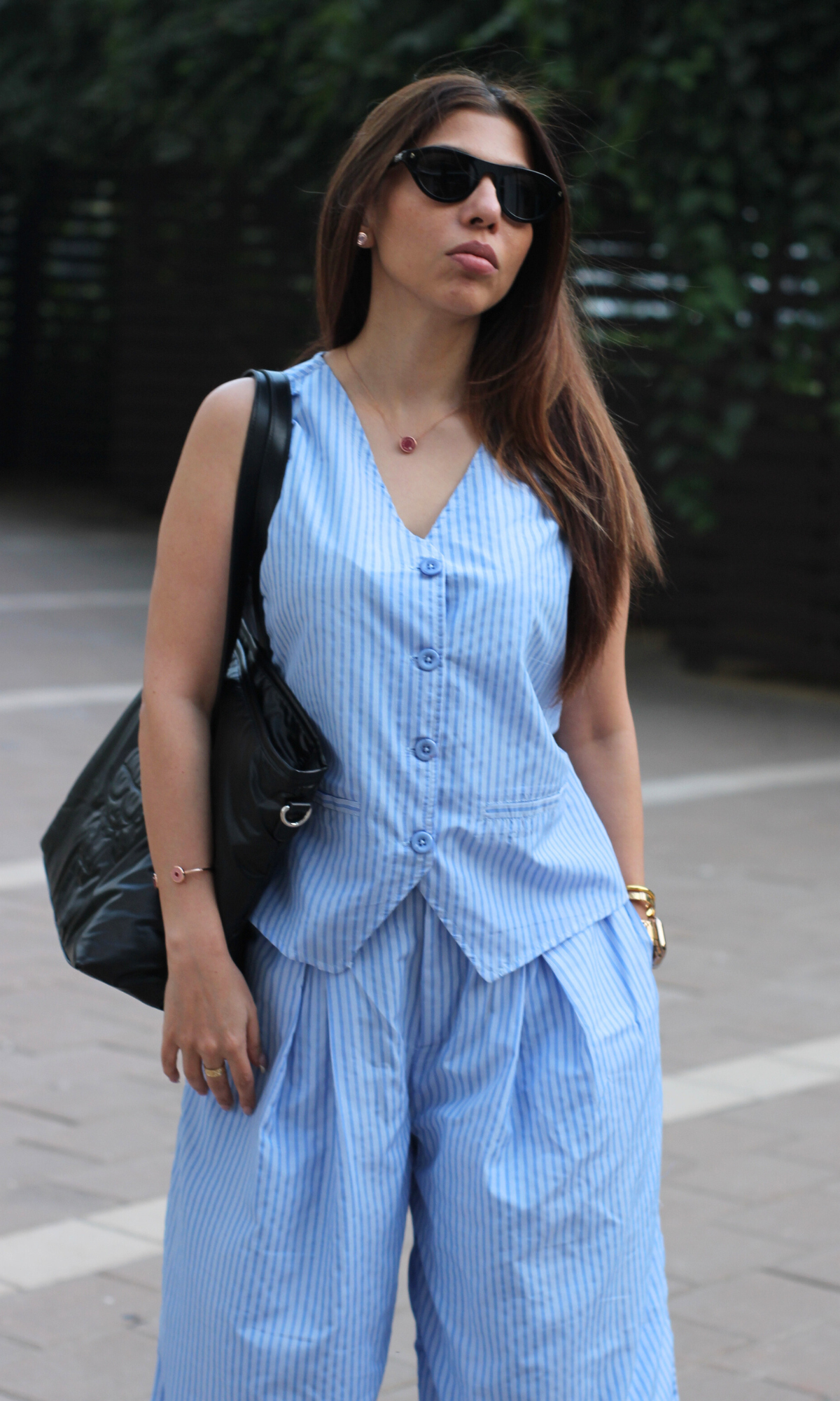 Women's blue pinstripe waistcoat paired with flowy wide-leg cotton trousers