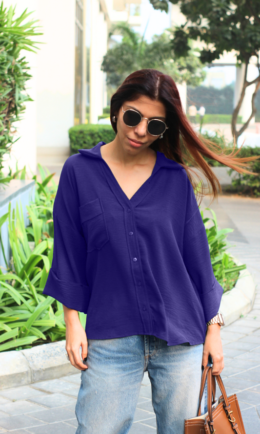 Minimalist soft violet button-down Flowing Shirt paired with neutral-toned wide-leg pants.