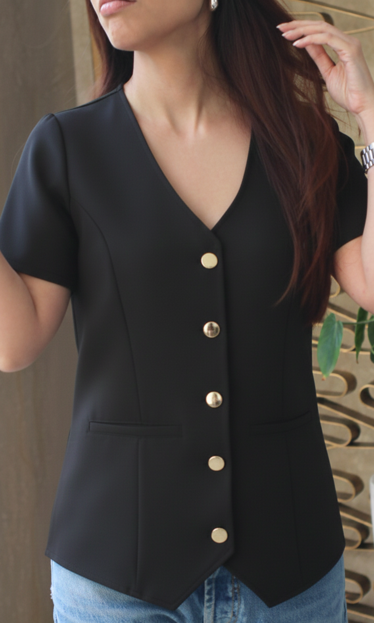 Close-up of onyx sleeved metallic buttoned waistcoat showing fabric texture and button accents