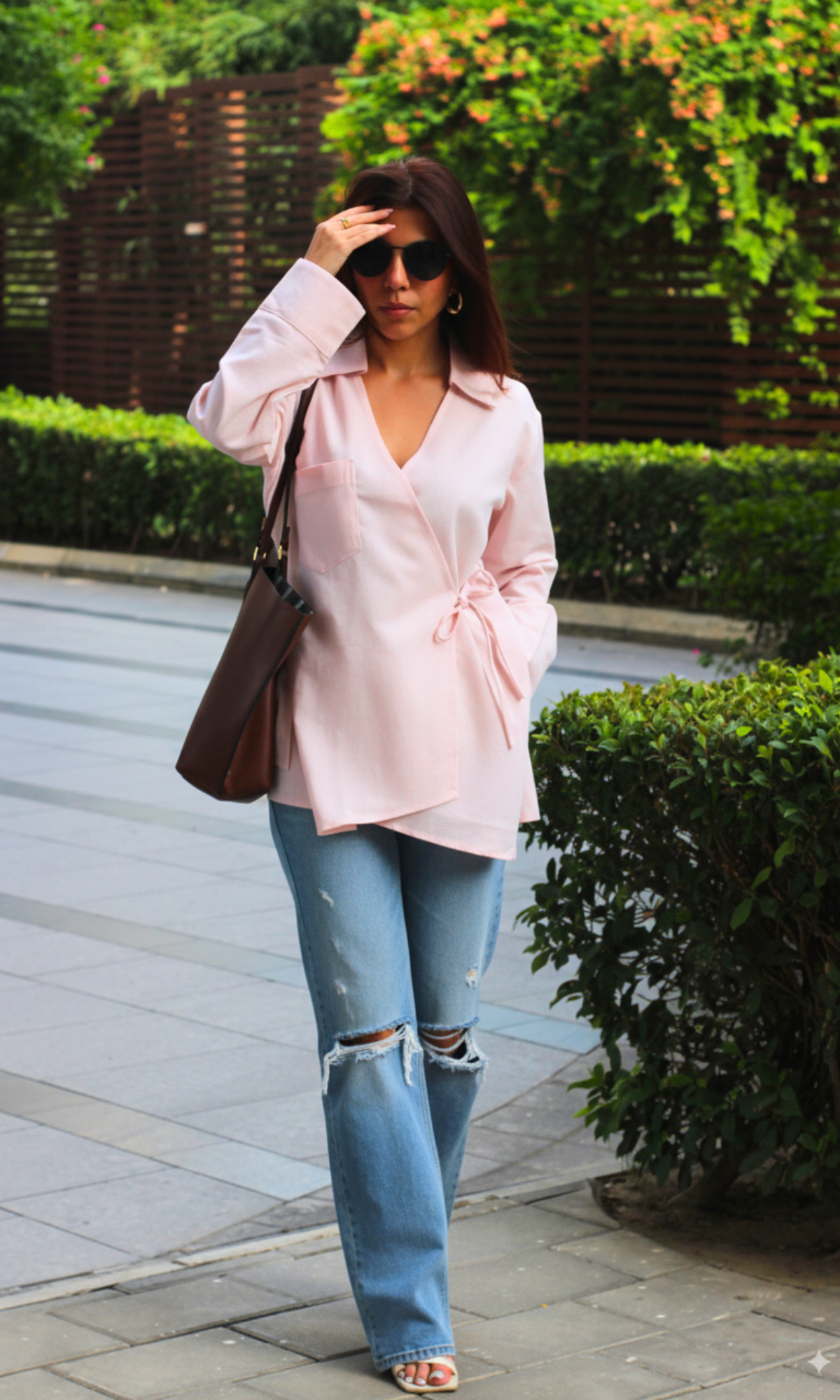 Elegant blush pink linen kimono blouse with cut-out detailing and a wrap-around tie closure.