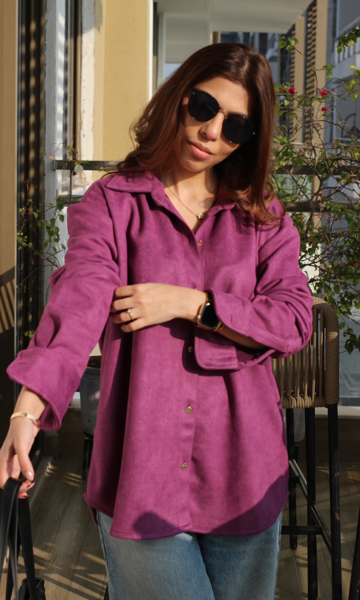 Front view of women’s berry suede shirt with shiny metallic button accents