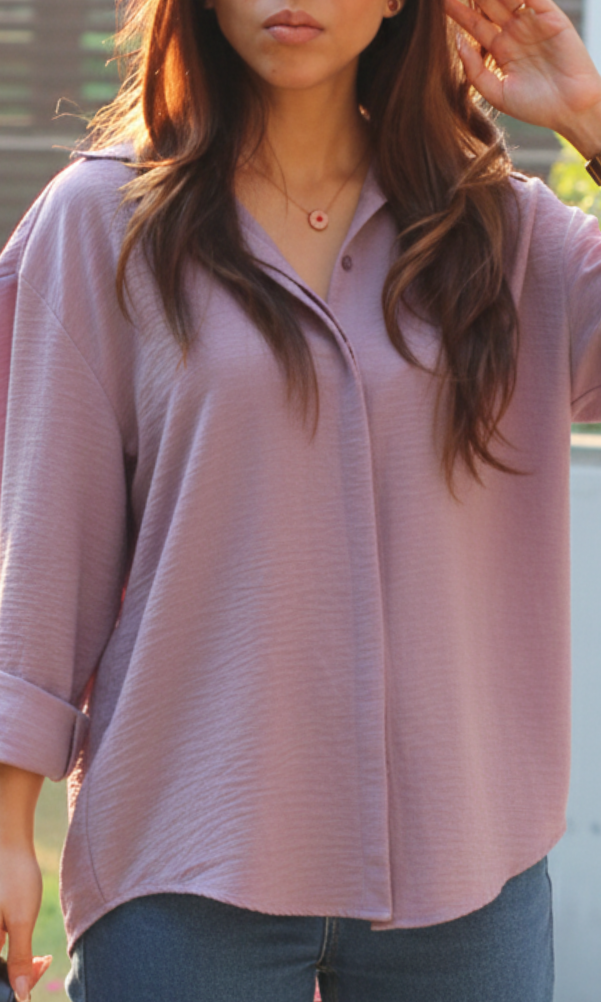Close-up of lavender flowing shirt showing textured light purple fabric and fluid movement
