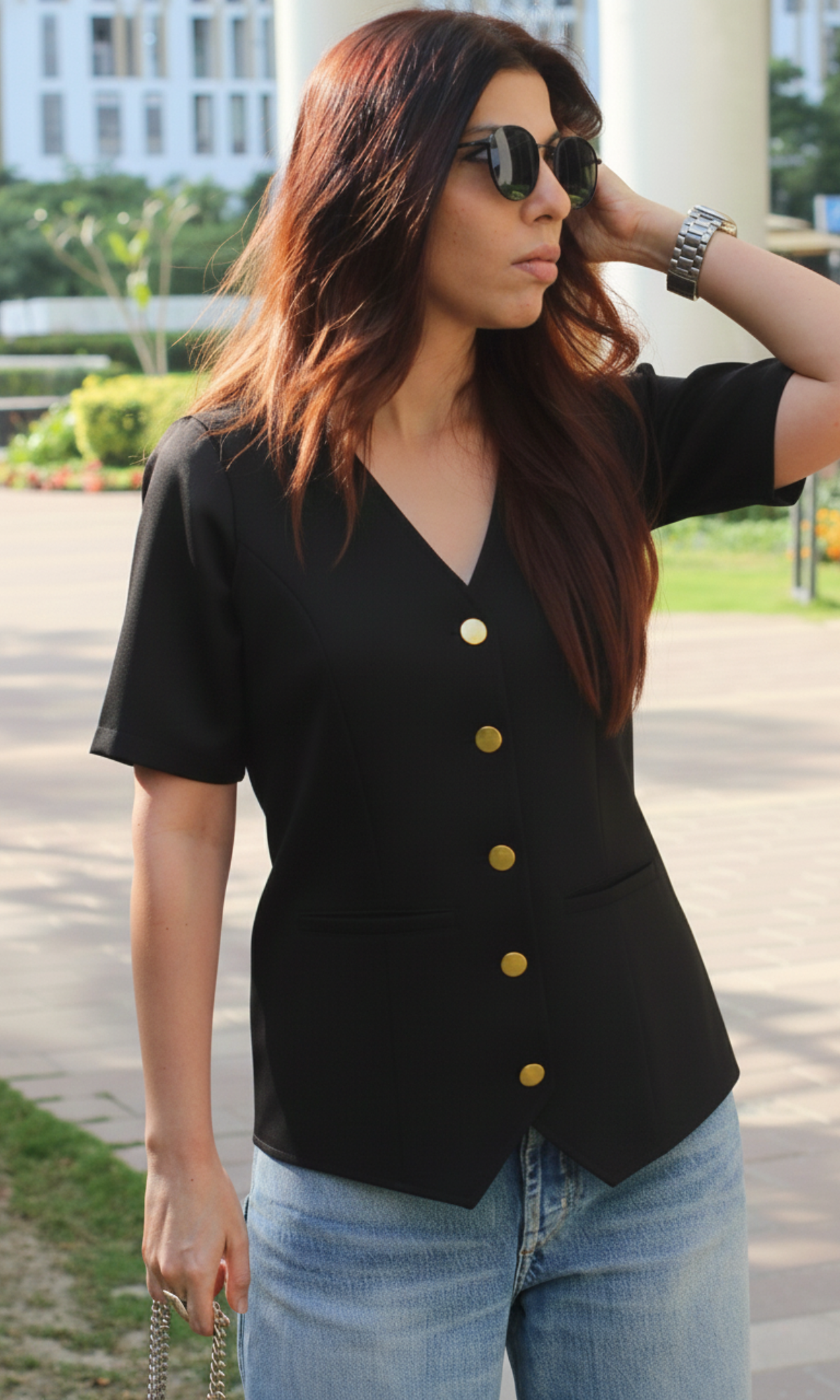 Angled view of onyx sleeved metallic buttoned waist coat emphasizing sleek black finish