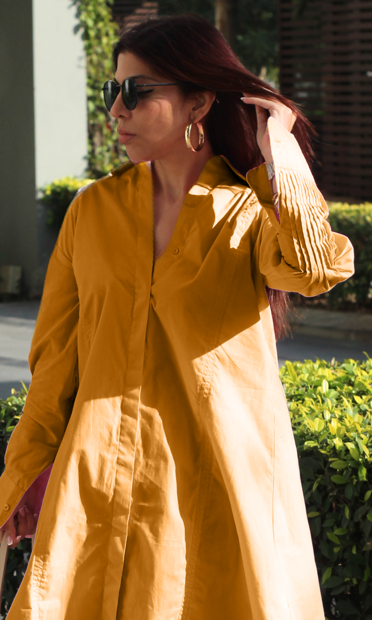 Effortless summer outfit: mustard yellow A-line shirt dress with long sleeves, styled for a casual yet polished daytime look.