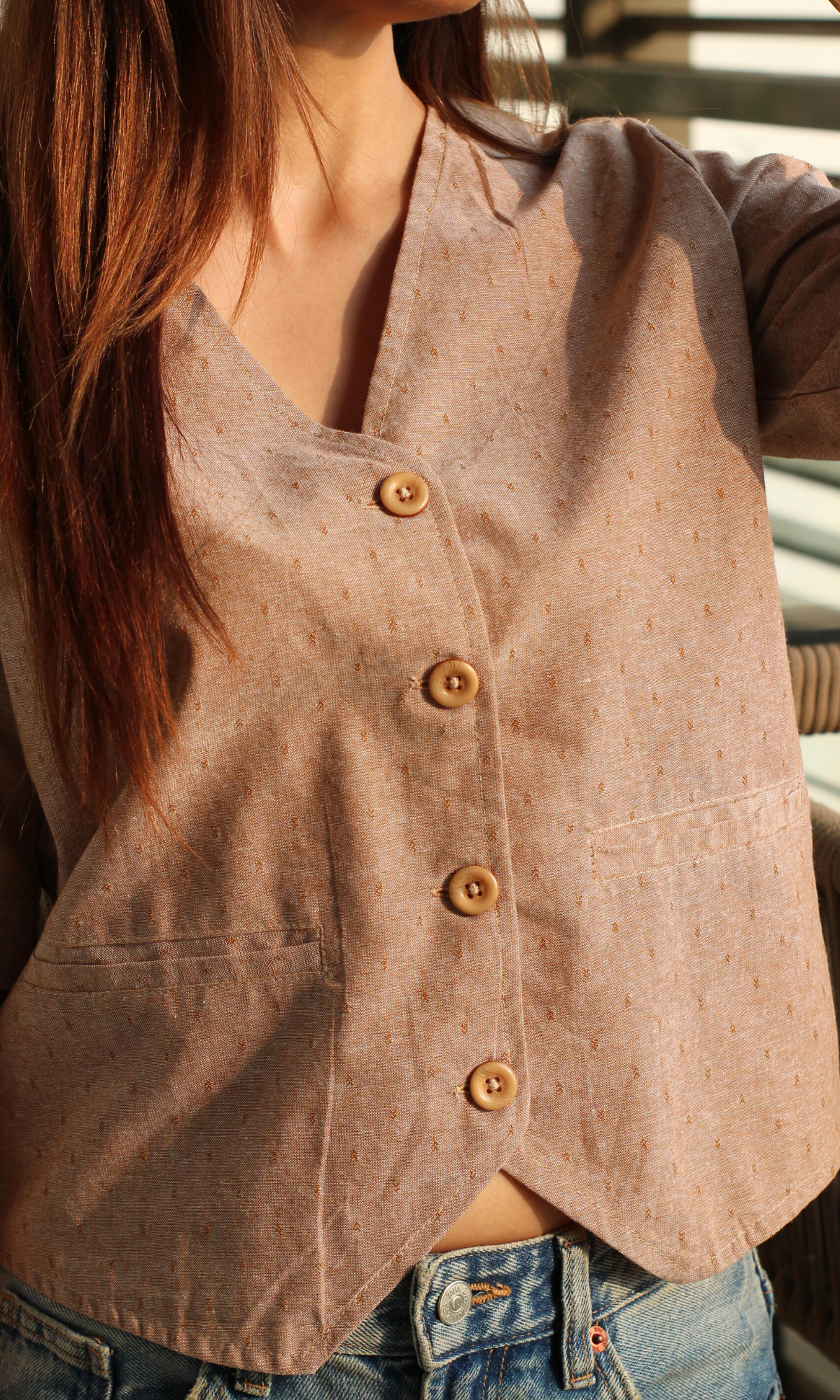 Close-up of brown dobby sleeved waistcoat showing textured fabric detail