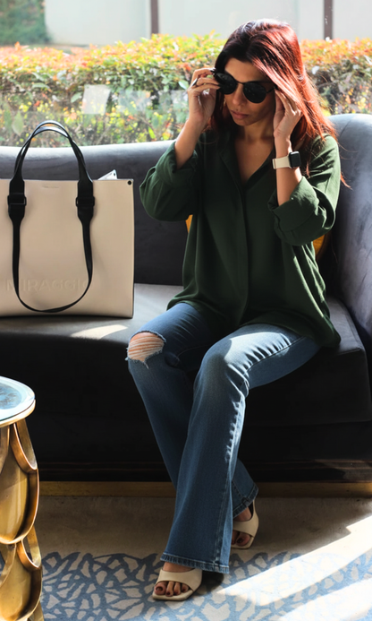 Model wearing fern green flowing shirt styled with casual bottoms