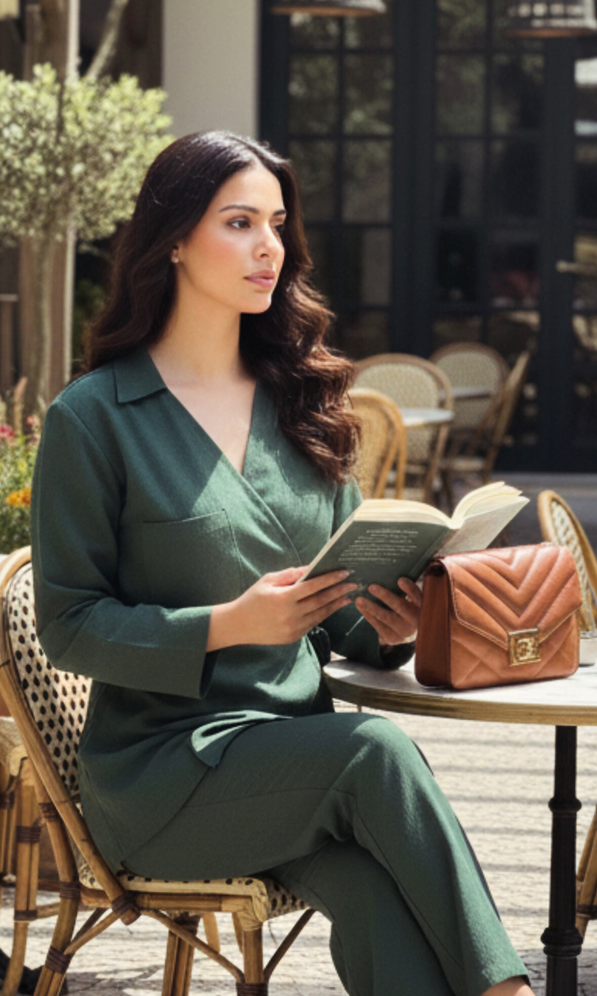 Woman wearing bottle green linen kimono blouse with cut accents and tie closure, paired with matching pants.
