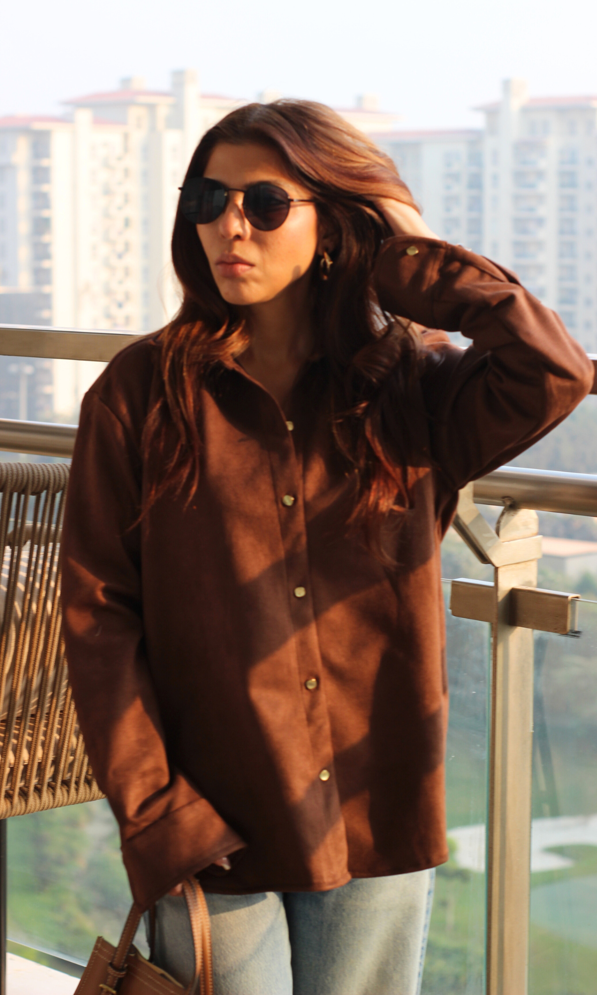 Rich brown suede shirt featuring subtle sheen, full sleeves and metallic button placket — versatile for elevated weekday or evening looks.