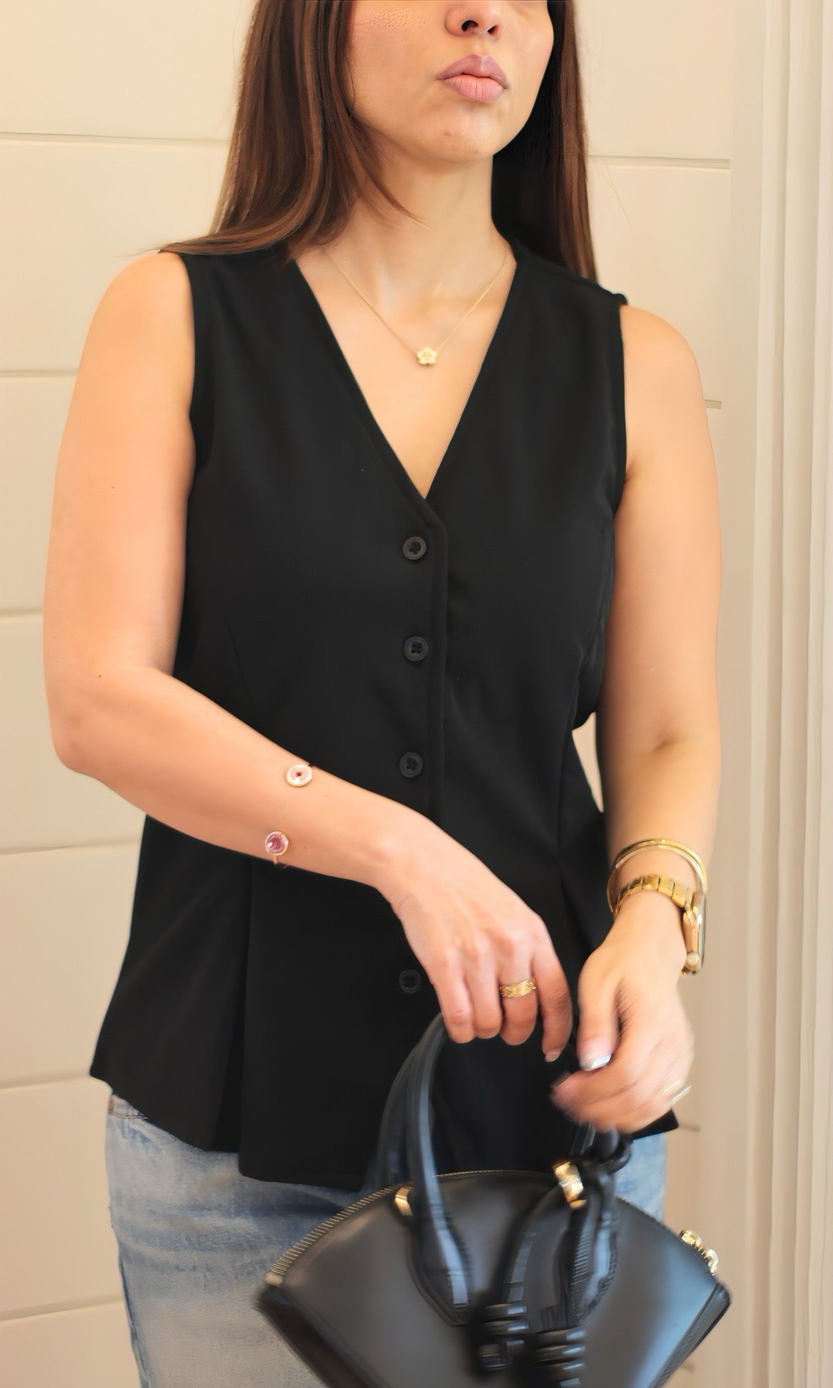 Black buttoned waist coat for women featuring a sleek sleeveless silhouette, structured fit, and front button closure — perfect for layering.