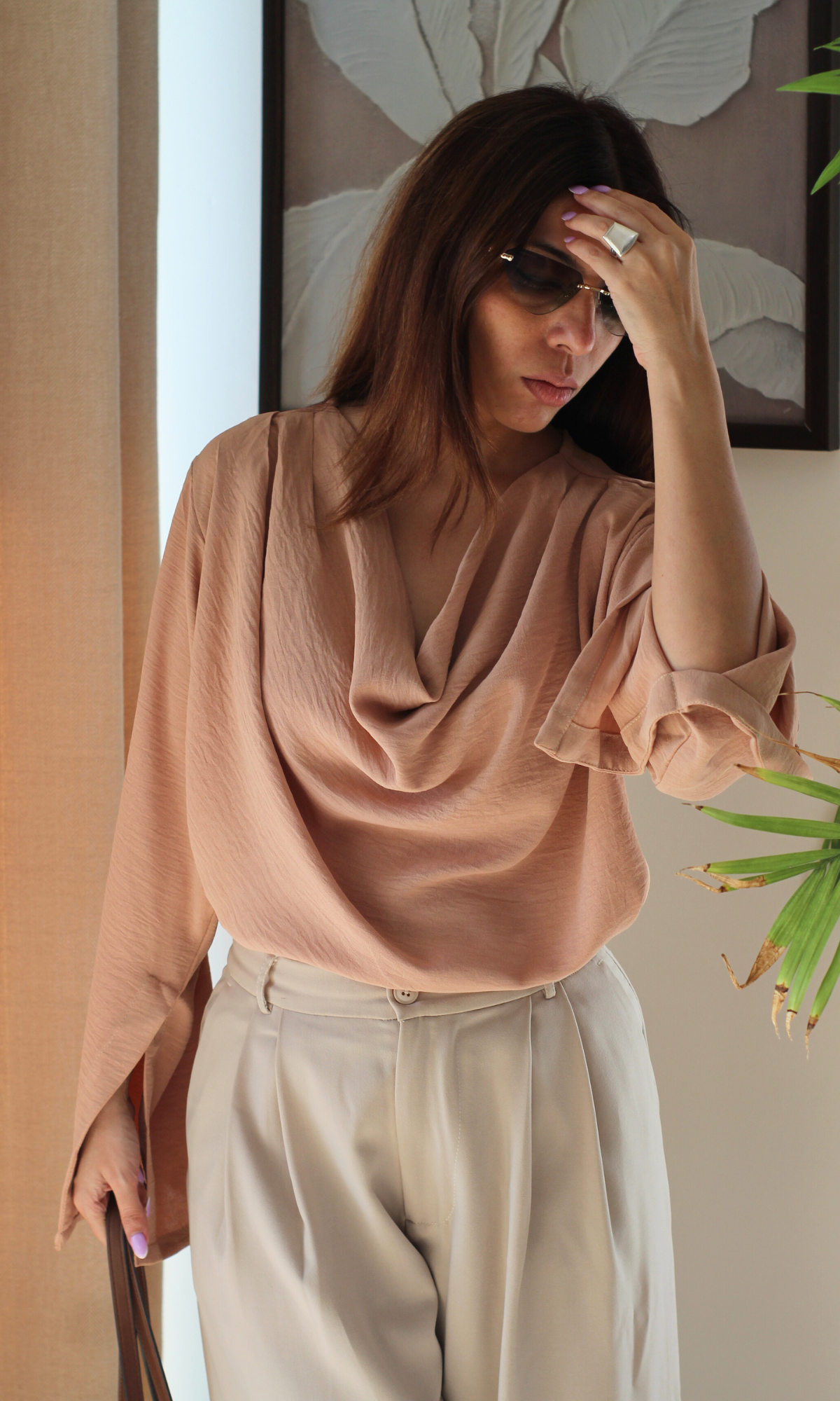 Women’s dusky rose cowl neck top with flowing slit sleeves, styled for a chic, effortless look.