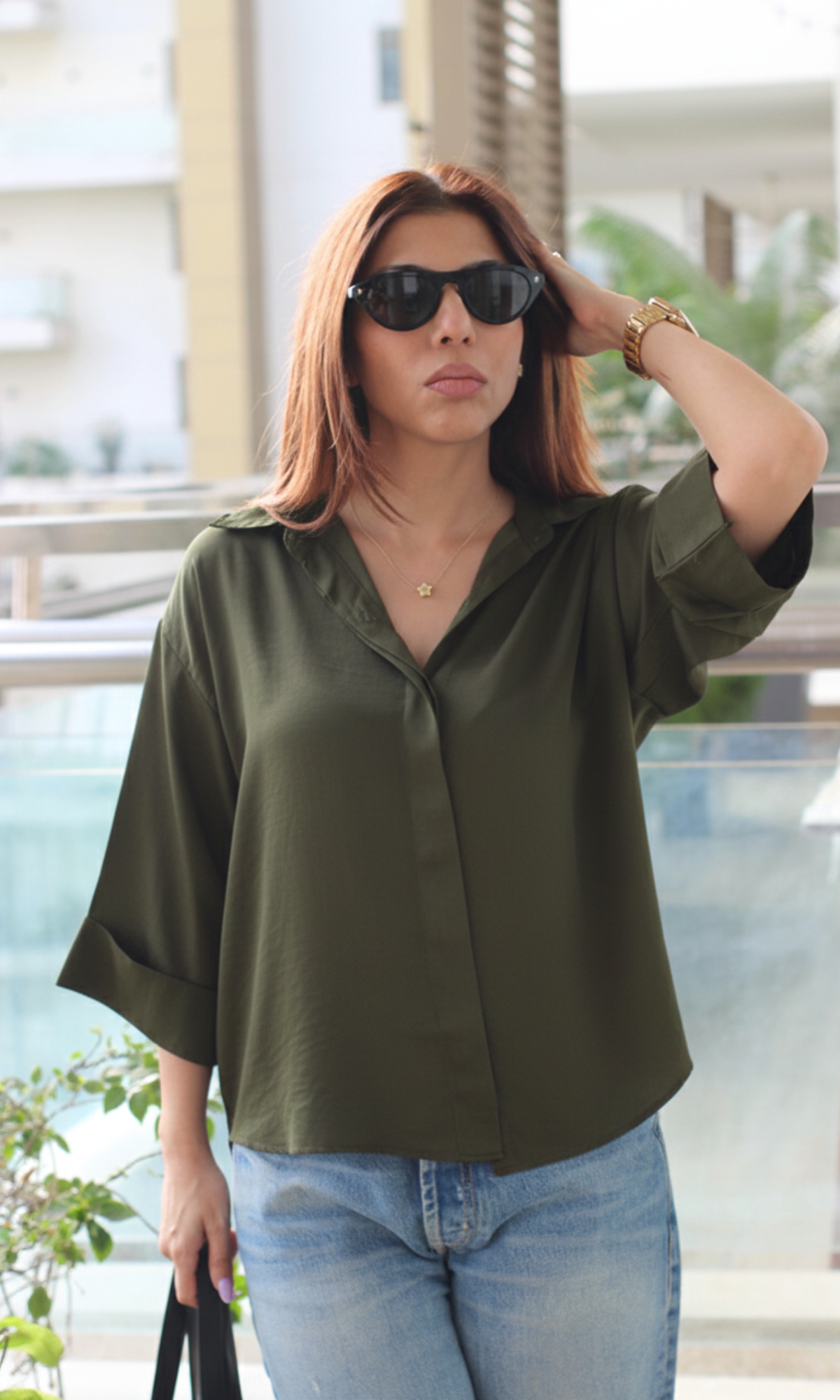 Front view of olive green loose shirt featuring soft sheen fabric and casual silhouette