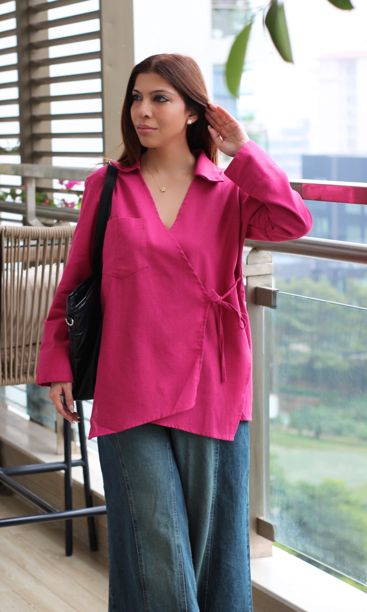 Women’s pink kimono top in textured linen fabric featuring cut-detail design and relaxed wrap fit.